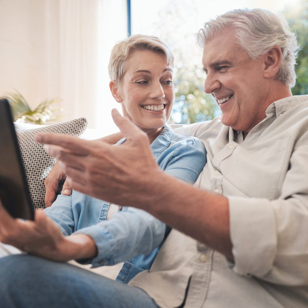 Tablet, love and senior couple with woman and man online for social media, video call or watching series and movies. Happy, smile and fun with an elderly male and female pensioner in a living room.